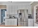 Bright kitchen featuring white cabinets, stainless steel appliances, and a marble countertop at 225 Ruby Forest Pkwy, Suwanee, GA 30024