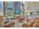 Spacious living room with a fireplace, high ceilings, and lots of natural light from large windows at 225 Ruby Forest Pkwy, Suwanee, GA 30024