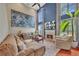 Comfortable living room featuring tall ceilings, large windows, a fireplace, and neutral-toned furniture at 225 Ruby Forest Pkwy, Suwanee, GA 30024