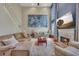 Bright living room featuring a cozy fireplace, large painting, and plush furnishings for comfortable living at 225 Ruby Forest Pkwy, Suwanee, GA 30024