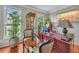 Charming home office with hardwood floors, large desk, seating area, and natural light at 225 Ruby Forest Pkwy, Suwanee, GA 30024