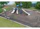 Aerial view of a fenced playground area featuring slides, climbing structures, and benches at 225 Ruby Forest Pkwy, Suwanee, GA 30024