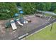 Aerial view of a fenced playground, with multiple slides and a swing set at 225 Ruby Forest Pkwy, Suwanee, GA 30024