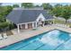 Overhead view of pool with pool house, lounge chairs, and tables at 225 Ruby Forest Pkwy, Suwanee, GA 30024