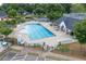 Community pool featuring ample seating, covered pavilion, and a clubhouse with a rooftop terrace at 225 Ruby Forest Pkwy, Suwanee, GA 30024