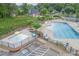 Community pool area with kiddie pool, lounge chairs, parking and lush landscaping at 225 Ruby Forest Pkwy, Suwanee, GA 30024