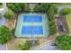 Overhead view of a complex with two tennis courts and playground surrounded by mature trees at 225 Ruby Forest Pkwy, Suwanee, GA 30024