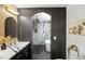 Modern bathroom with a double vanity, unique lighting, and a luxurious walk-in shower at 2541 Peyton Woods Sw Trl, Atlanta, GA 30311