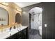 Modern bathroom with a double vanity, unique lighting, and a luxurious walk-in shower at 2541 Peyton Woods Sw Trl, Atlanta, GA 30311