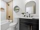 Chic bathroom with modern fixtures, a bathtub, and a sleek vanity with an arched mirror at 2541 Peyton Woods Sw Trl, Atlanta, GA 30311