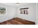 Bright bedroom featuring hardwood floors, natural light, and neutral decor at 2541 Peyton Woods Sw Trl, Atlanta, GA 30311