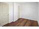 Clean bedroom with wood floors, white trim, and simple doors at 2541 Peyton Woods Sw Trl, Atlanta, GA 30311