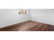 Minimalist bedroom with wood floors, white trim, and a bright window at 2541 Peyton Woods Sw Trl, Atlanta, GA 30311