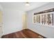 Bright bedroom with hardwood floors, a neutral color scheme, and a large window view at 2541 Peyton Woods Sw Trl, Atlanta, GA 30311