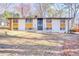 Midcentury home with modern design elements and a spacious front yard at 2541 Peyton Woods Sw Trl, Atlanta, GA 30311