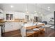 Modern kitchen featuring white cabinets, quartz countertops, pendant lighting and open to living room at 2541 Peyton Woods Sw Trl, Atlanta, GA 30311