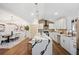 Bright kitchen featuring white cabinets, quartz countertops, a vaulted ceiling, and an open floor plan at 2541 Peyton Woods Sw Trl, Atlanta, GA 30311