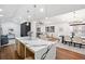Modern kitchen island with quartz countertops, pendant lights and open floorplan with dining and living area at 2541 Peyton Woods Sw Trl, Atlanta, GA 30311