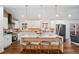 Modern kitchen featuring a quartz island, stainless steel appliances and pendant lighting with an open floorplan at 2541 Peyton Woods Sw Trl, Atlanta, GA 30311