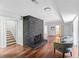 Cozy living room features a brick fireplace, wood flooring, and stairway access at 2541 Peyton Woods Sw Trl, Atlanta, GA 30311
