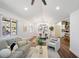 Bright living room featuring hardwood floors, natural light, modern decor and an open view into the kitchen at 2541 Peyton Woods Sw Trl, Atlanta, GA 30311