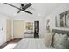 Stylish main bedroom with a ceiling fan, hardwood floors, and a doorway to the bathroom at 2541 Peyton Woods Sw Trl, Atlanta, GA 30311