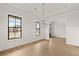 Bright living room with large windows, hardwood floors, and elegant trim details at 5424 Gallagher Ct, Powder Springs, GA 30127