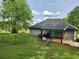 Spacious backyard with a deck, green lawn, and a mature tree at 6567 Post Rd, Douglasville, GA 30135