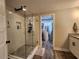 Stylish bathroom featuring a modern walk-in shower with glass door and elegant fixtures with a walk-in closet nearby at 6567 Post Rd, Douglasville, GA 30135