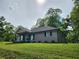 Charming single-story home with a green lawn and mature trees at 6567 Post Rd, Douglasville, GA 30135