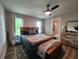 Relaxing bedroom with a stylish wooden headboard, comfortable bed, and a ceiling fan for added comfort at 6567 Post Rd, Douglasville, GA 30135