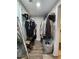 Well-organized walk-in closet with ample storage space for clothing, shoes, and accessories with stylish mirror at 6567 Post Rd, Douglasville, GA 30135