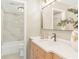 Well-lit bathroom featuring modern vanity, neutral countertops, and shower-tub combo with attractive tile surround at 1150 Collier Nw Rd # D20, Atlanta, GA 30318