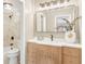 Updated bathroom featuring a modern vanity, stylish mirror, and tiled shower with bronze fixtures at 1150 Collier Nw Rd # D20, Atlanta, GA 30318