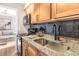 Updated kitchen featuring stone counters, black appliances, and modern fixtures at 1150 Collier Nw Rd # D20, Atlanta, GA 30318