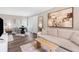 Comfortable living room featuring a sofa, modern art, and dark laminate wood flooring at 1150 Collier Nw Rd # D20, Atlanta, GA 30318