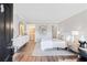 Bright main bedroom with modern decor, wood-look floors, and ensuite bathroom at 1150 Collier Nw Rd # D20, Atlanta, GA 30318