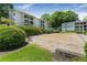 Apartment complex featuring a sand volleyball court surrounded by lush shrubbery at 1150 Collier Nw Rd # D20, Atlanta, GA 30318