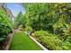 Backyard featuring a putting green and lush landscape, ideal for outdoor activities and relaxation at 2434 Soft Maple St, Atlanta, GA 30360