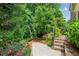 Brick stairs leading to a backyard with lush greenery and landscape, creating a private outdoor oasis at 2434 Soft Maple St, Atlanta, GA 30360