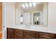 Bathroom featuring dark wood cabinets, large mirror, and modern lighting fixtures over the vanity at 2434 Soft Maple St, Atlanta, GA 30360