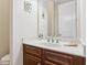 Bathroom with dark wood cabinet, white countertop with modern faucet, and decorative wall art at 2434 Soft Maple St, Atlanta, GA 30360