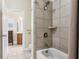 Bathroom with tiled shower over tub, and view into another bathroom with tile flooring and vanity at 2434 Soft Maple St, Atlanta, GA 30360
