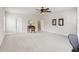 Bright bedroom featuring neutral carpet, ceiling fan, and ample space for relaxation or office setup at 2434 Soft Maple St, Atlanta, GA 30360