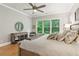 Bright bedroom with large window, ceiling fan, dresser, and accent pillows at 2434 Soft Maple St, Atlanta, GA 30360