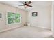 Bright bedroom with plush carpeting and a large window overlooking the green landscape at 2434 Soft Maple St, Atlanta, GA 30360