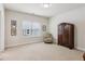 Carpeted bedroom with chair and cabinet by the window providing a cozy atmosphere at 2434 Soft Maple St, Atlanta, GA 30360