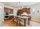 Well-equipped kitchen with a large island, dark wood cabinets, and stainless steel appliances at 2434 Soft Maple St, Atlanta, GA 30360