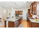 Spacious kitchen with a granite island, dark cabinetry, and stainless steel appliances at 2434 Soft Maple St, Atlanta, GA 30360