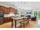 Open-concept kitchen featuring an island with seating, granite countertops, and stainless steel appliances at 2434 Soft Maple St, Atlanta, GA 30360